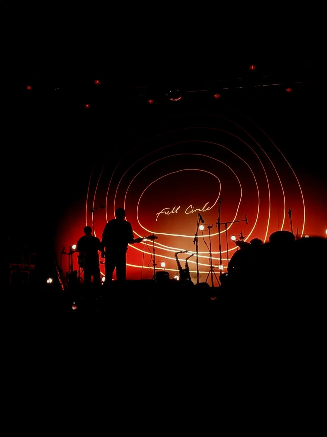 Silhouettes on a stage lit in red