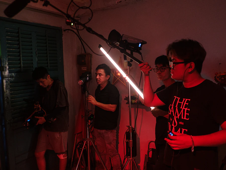 Film crew working on set under red light
