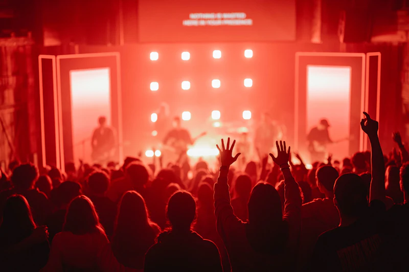 Crowd in front of a stage lit in red