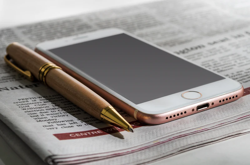 Smartphone resting on a printed newspaper