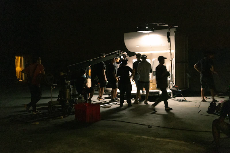 Silhouetted crew setting up a shoot