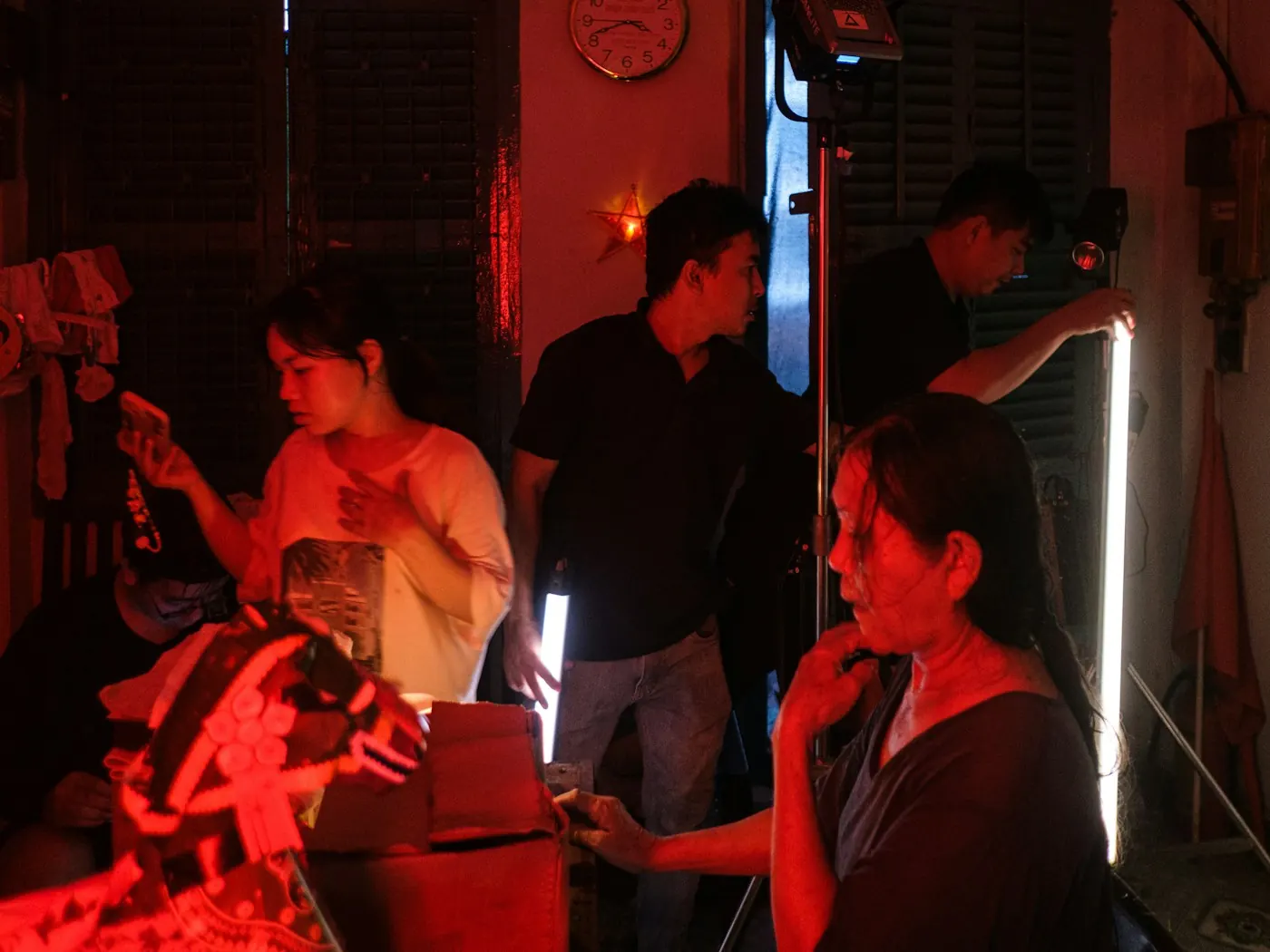 Crew setting up a shoot under red light